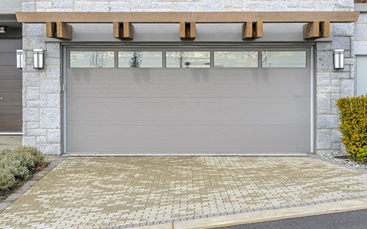 Gray garage door on brick garage